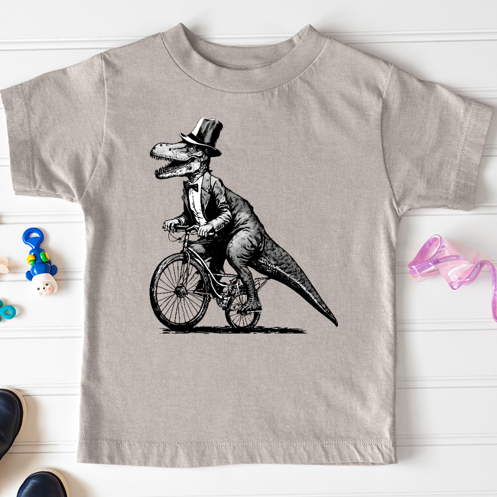 Viking Goods Dinosaur Riding a Bike Toddler Tee Heather Stone / 2T