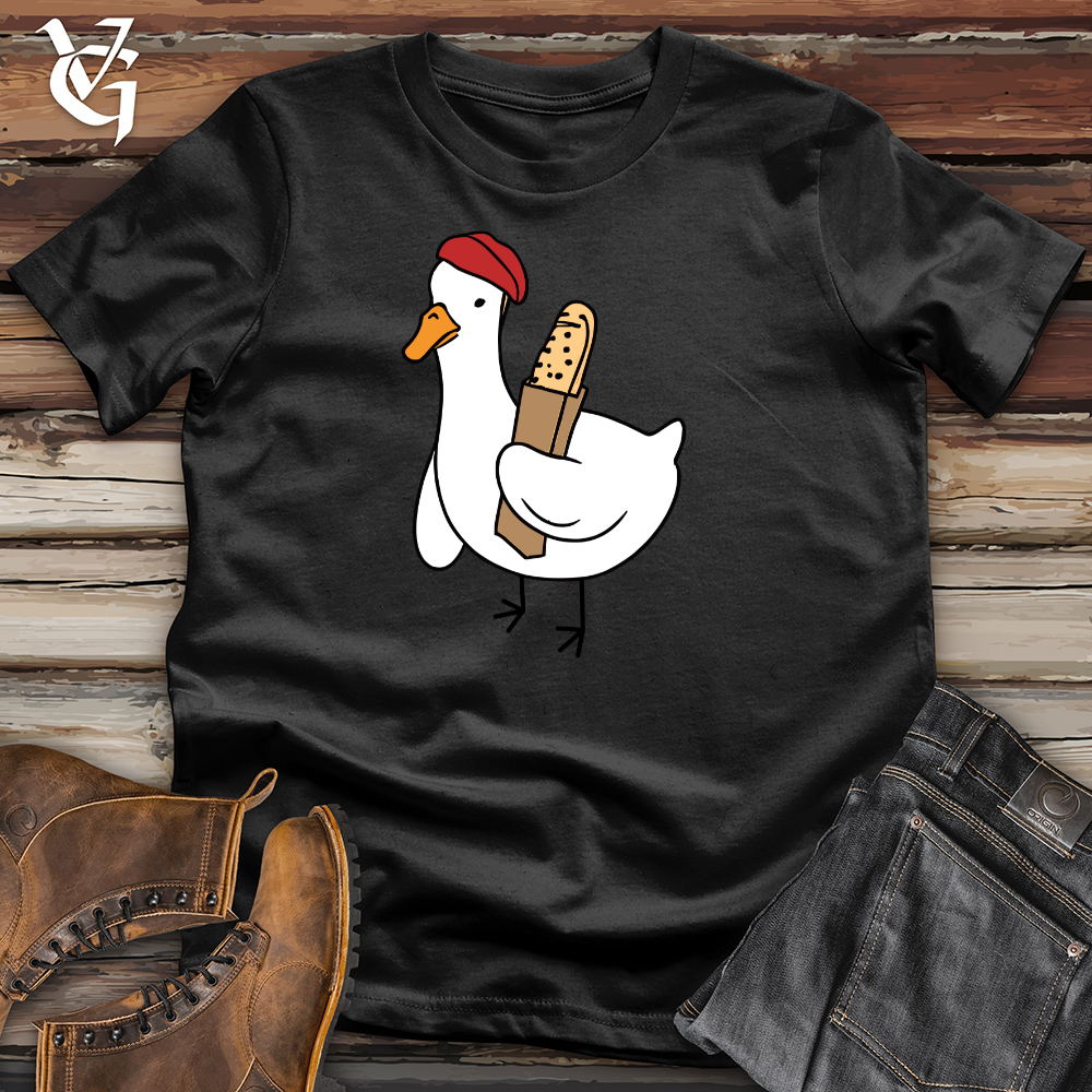 A Red Hat Wearing Duck Holding a Baguette Cotton Tee