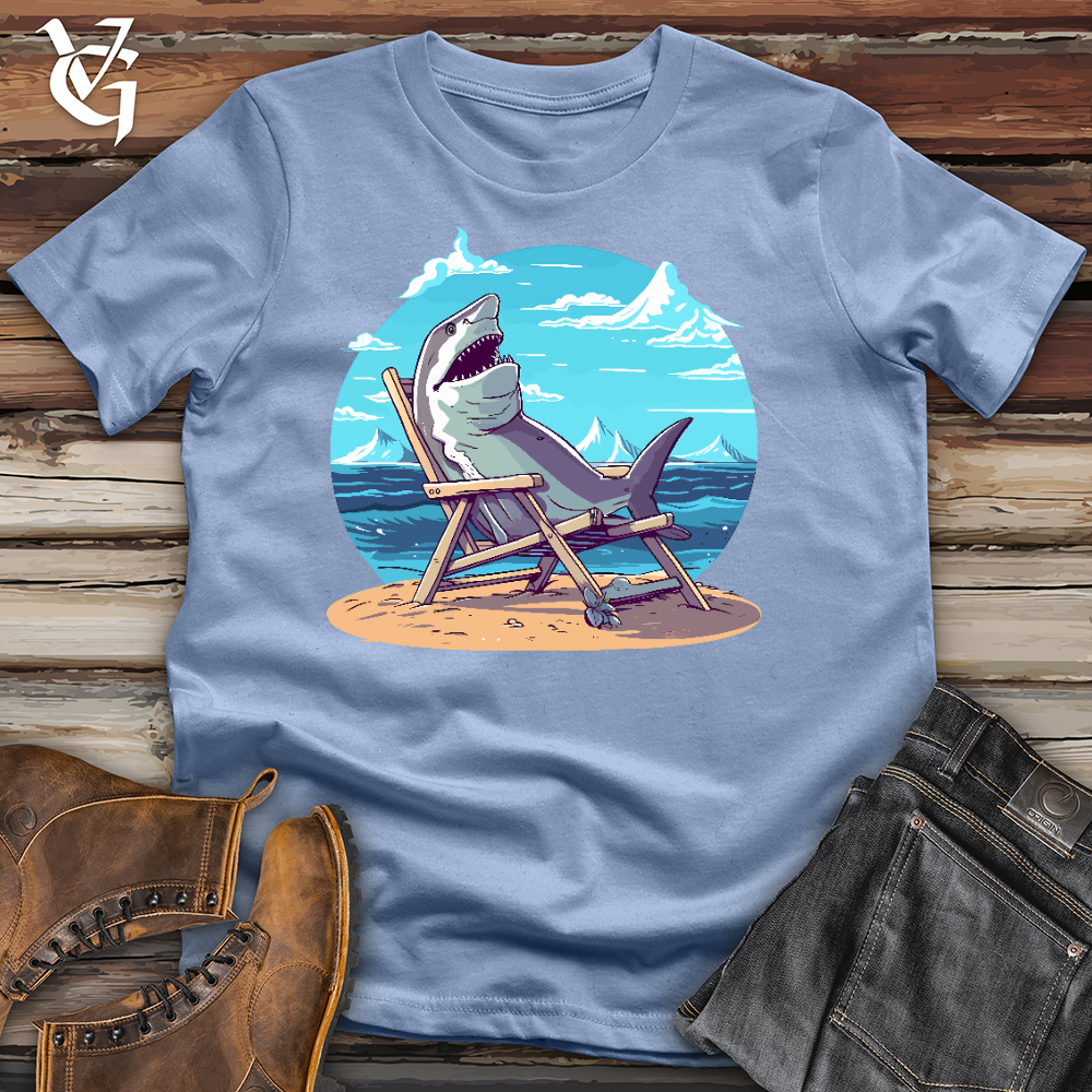 Viking Goods Shark Sitting in a Beach Chair in the Sand Cotton Tee Baby Blue / L